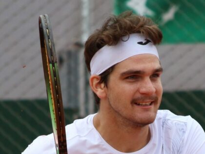 Thiago Seyboth Wild em Roland Garros 2023, com o rosto inteiro e raquete em quadra.